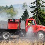 Officials with Clallam County Fire District 3 plan to make a decision in 2023 whether or not to go to voters to approve more funding to add staff, apparatuses and/or new fire stations. Here, firefighters fight a brush fire in July 2021 west of Sequim. (Matthew Nash/Olympic Peninsula News Group)