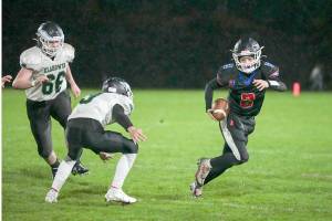 Steve Mullensky/for Peninsula Daily News

East Jefferson’s Brody Moore dodges away from Klahowya players and picks up yardage during the Rivals' 18-13 Senior Night win at Memorial Field on Friday in Port Townsend.