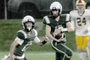 KEITH THORPE/PENINSULA DAILY NEWS
Port Angeles' Blake Sohlberg, right, is followed by teammate Kason Albaugh, leaving Kingston's Noah Walter far behind on Friday at Port Angeles Civic Field.