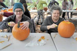 Kathy Durr, 70, left, and Charle Crocker, 69, both of Port Angeles, try their hands at carving jack-o-lanterns during a pumpkin carving workshop on Saturday at the Port Angeles Fine Arts Center. The workshop, which drew about 50 participants, was part of the centers second annual Celebration of Shadows, a tribute to the season of Halloween. The event also included a mask-making workshop, a carved pumpkin contest, spooky walks and an outdoor movie. (Keith Thorpe/Peninsula Daily News)