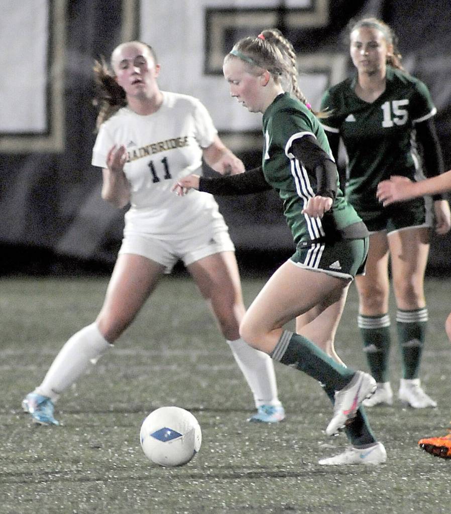 Port Angeles Isabelle Felton, center, tries to slip past Bainbridges Ellie Murray, left, as teammate Kennedy Rognlien looks on at right on Tuesday in Port Angeles. (Keith Thorpe/Peninsula Daily News)