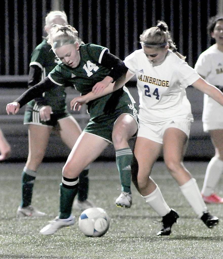 Port Angeles Anna Petty, left, fights for control with Bainbridges Grace Rich on Tuesday at Peninsula College. (Keith Thorpe/Peninsula Daily News)