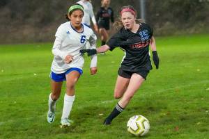 Steve Mullensky/for Peninsula Daily News


Rival’s Avo Shiflett, #15, beats out Viking’s Lucy Carrel for control during a rain soaked game on Tuesday played in Port Townsend’s Memorial Field.