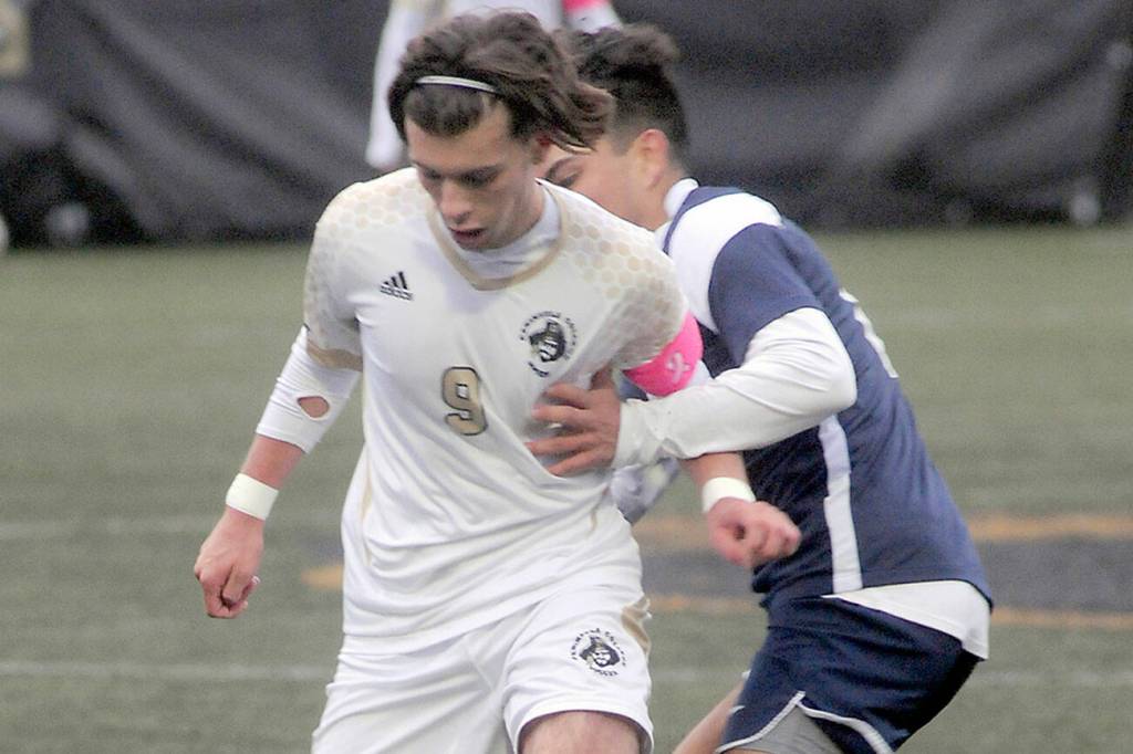 KEITH THORPE/PENINSULA DAILY NEWS
Peninsula's Pau Vivas, front, fends off Bellevue's Bryan De La Rosa during Wednesday's match at Wally Sigmar Field in Port Angeles.