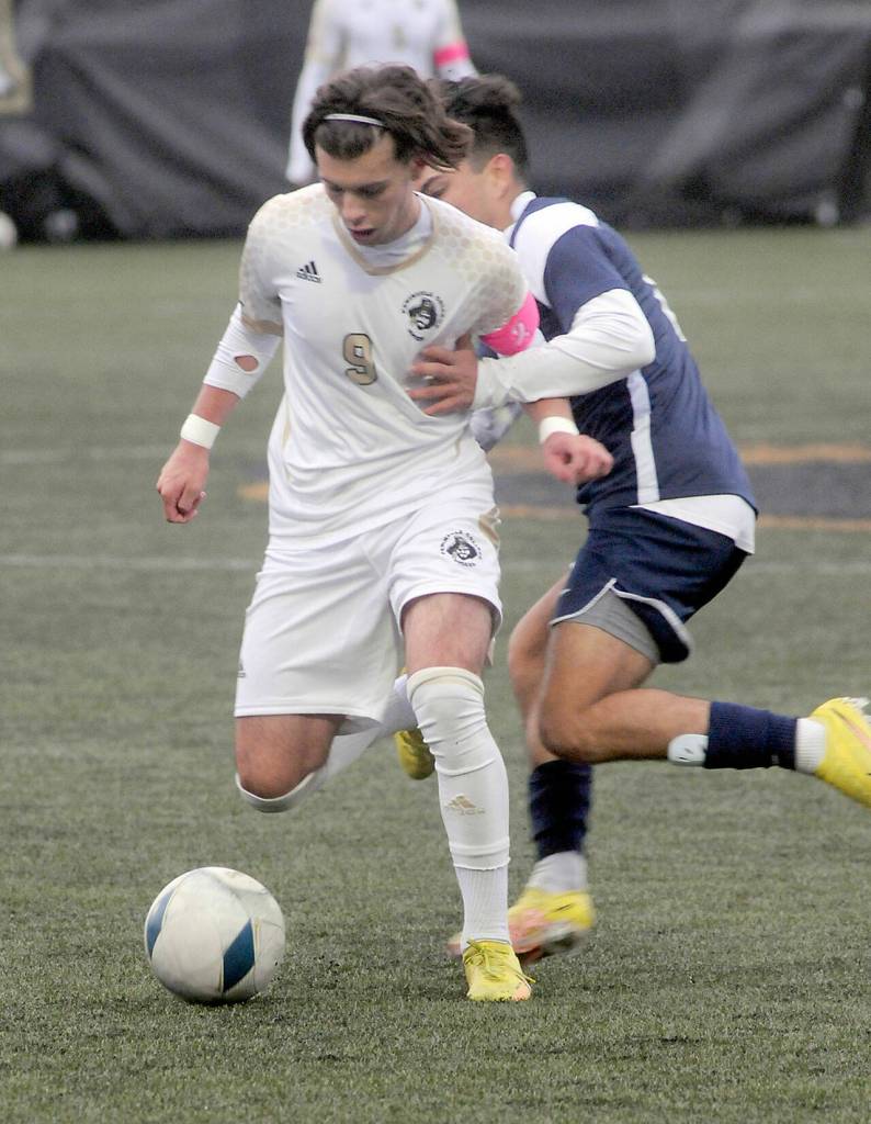 KEITH THORPE/PENINSULA DAILY NEWS
Peninsula's Pau Vivas, front, fends off Bellevue's Bryan De La Rosa during Wednesday's match at Wally Sigmar Field in Port Angeles.