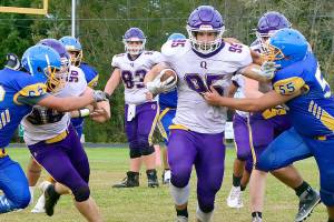 Quilcene’s Deakon Budnek (95) rumbles through the Crescent defense for a long gainer. Pursuing on the play for Crescent is Tommy Leonard (62) and  Jeremy Charles (55). (Dave Logan/for Peninsula Daily News)