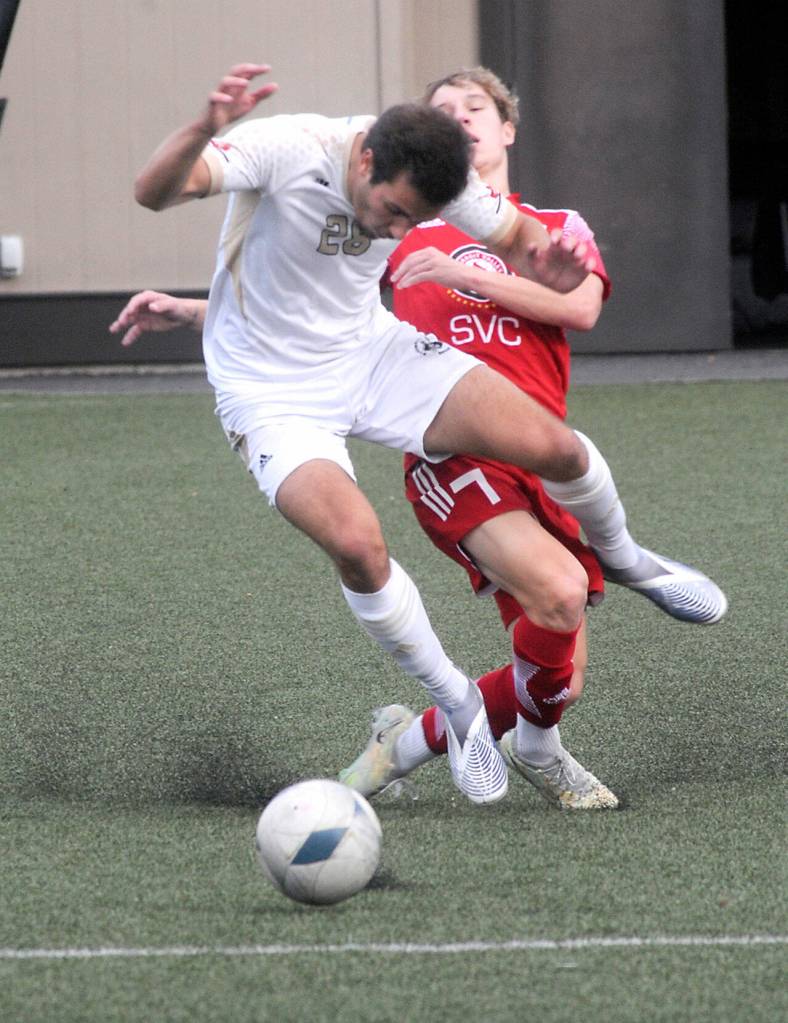 Peninsulas Kai Biegler, front, tangles with Skagit Valleys Hugo Mariage during Saturdays match at Wally Sigmar Field in Port Angeles. (Keith Thorpe/Peninsula Daily News)