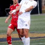 Peninsulas Shu Kato, right, brings down a flying ball as Skagits Shingo Yamada keeps watch during Saturdays match in Port Angeles. (Keith Thorpe/Peninsula Daily News)