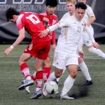 KEITH THORPE/PENINSULA DAILY NEWS
Peninsula's Don Vaios Dovas, front right, avoids a tackle by Skagit's Aurelien Habasque, left, as Ryosuke Tanaka of Skagit Valley, and Tim Desser and Gabriel Kiekenback of Peninsula look on from the backfield on Saturday in Port Angeles.