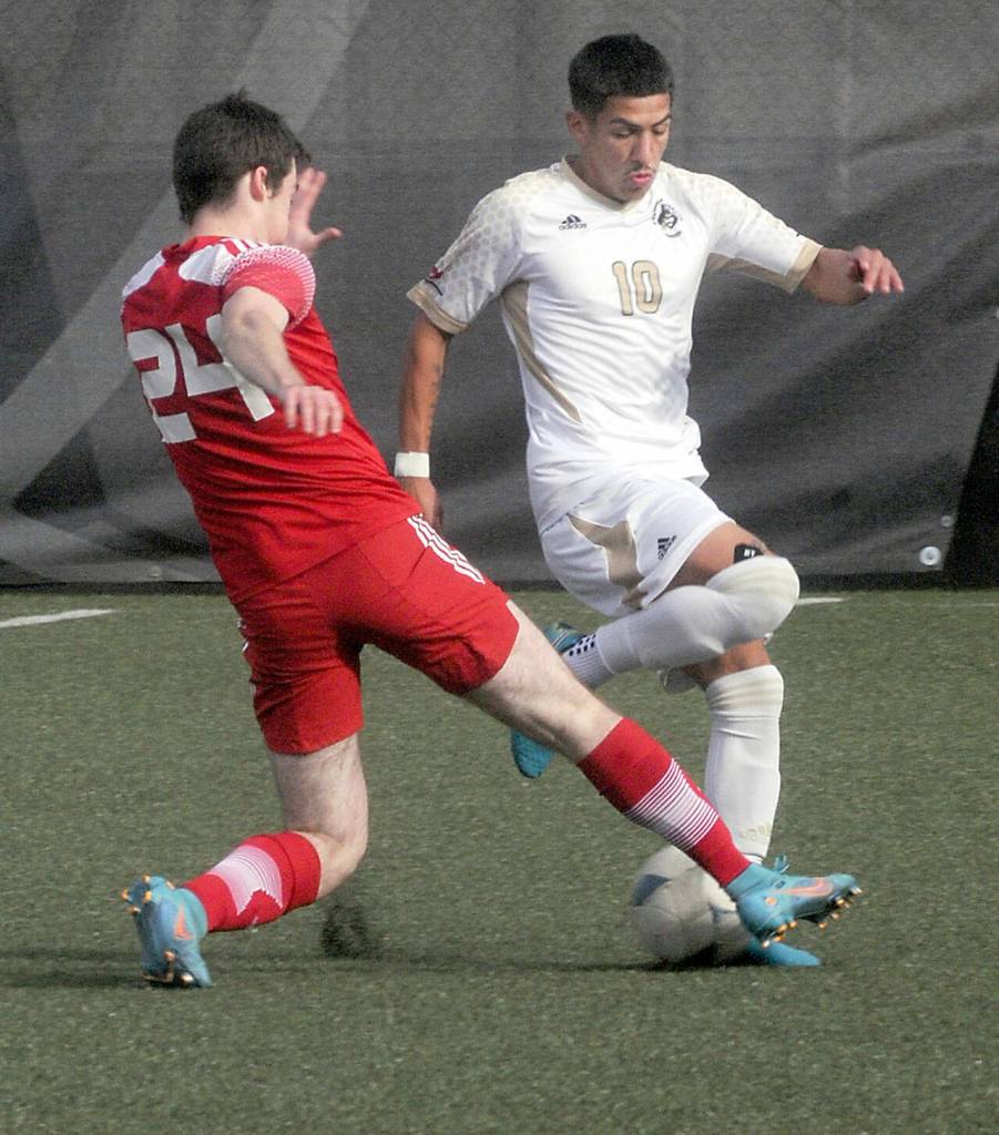 KEITH THORPE/PENINSULA DAILY NEWS Peninsulas Fernando Tavares, left, avoids a tackle by Skagit Valleys Ben Laycock on Saturday at Peninsula College.