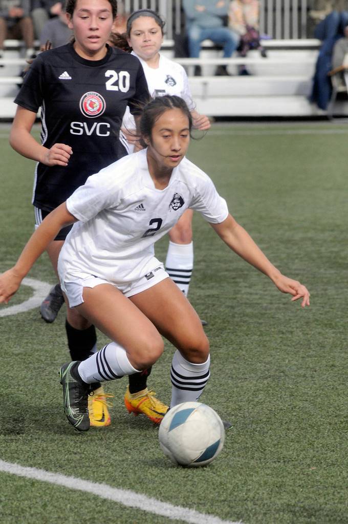 Peninsulas Briana-Jean Tanaka, front, advances the ball as Skagit Valleys Brianna Navarro and teammate Taya Bohenko come up from behind during Saturdays match in Port Angeles. (Keith Thorpe/Peninsula Daily News)