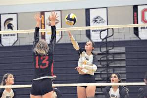 Forks' Chloe Gaydeski-St. John (6) hits against Toledo's Eden Jones (13) Saturday afternoon in Forks during the District IV 2B tournament. Also in the action are Forks' Erika Williams (left) and Kaidence Rigby. Forks defeated the Riverhawks 3-1 but split on the day with a loss to Adna 3-1. Forks is still alive in the postseason and is scheduled to play Ilwaco in Ocosta at 5:30 p.m. Wednesday. (Lonnie Archibald/for Peninsula Daily News)