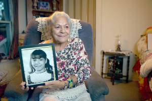 Georgina Sappier-Richardson (Passamaquoddy) holds her childhood photo. (Jeremy Dennis)