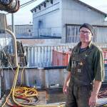 Blaise Holly, new owner of Haven Boatworks at the Boat Haven in Port Townsend, is on board the Molly, a commercial boat his company is servicing. In the background is Integrated Marine Systems, a building to which Holly will be re-locating soon. (Steve Mullensky/for Peninsula Daily News)