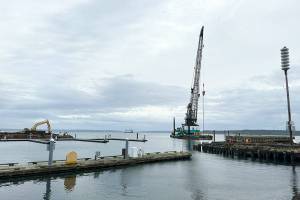 The north end of the Point Hudson Marina is gone, leaving a gaping opening to the marina until it is replaced with a newer breakwater, expected to be in March. The south side will be replaced after the Wooden Boat Festival next September. The M/V Salish is in the background and completing a Monday morning run from Coupeville to Port Townsend. (Steve Mullensky/for Peninsula Daily News)