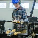 Emily Matthiessen /Olympic Peninsula News Group
Matthew Barton, membership director for the Strait Turners, demonstrates how to make a Christmas tree ornament on his lathe. He is using a a spindle roughing gouge to remove of the first layer of the wood, local cedar. His shop is large and filled with tools, but he says that beginners need only a few tools to get started and one could turn out a Christmas tree in half a day. The Strait Turners have a couple lathes that they lend to members.