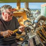 Emily Matthiessen / Olympic Peninsula News Group
Sequim resident Dave Sellman, five-year member of the Strait Turners, works at a lathe that he set up at an angle so that he could turn wood in his wheelchair. He says that wood turning is accessible for many people who have physical restrictions or space restrictions. His shop is small but contains all the equipment he needs to turn out beautiful pieces that he gives to his loved ones or sells at Shipley Center events, donating all proceeds to charity, especially the VOHCC. He says, "I hope that other wheelchair bound individuals will realize that they can be creative and stretch their boundaries."