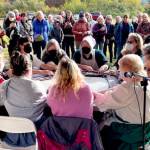 Women at the Quilcene Fiber Festival on Saturday demonstrate the Scottish Gaelic tradition of wool waulking, which involves beating damp wool to soften it as they sing. The Quilcene Fiber Festival held Saturday at Worthington Park featured demonstrations on many aspects of wool production, as well as vendors and hands-on workshops. (Paula Hunt/Peninsula Daily News)