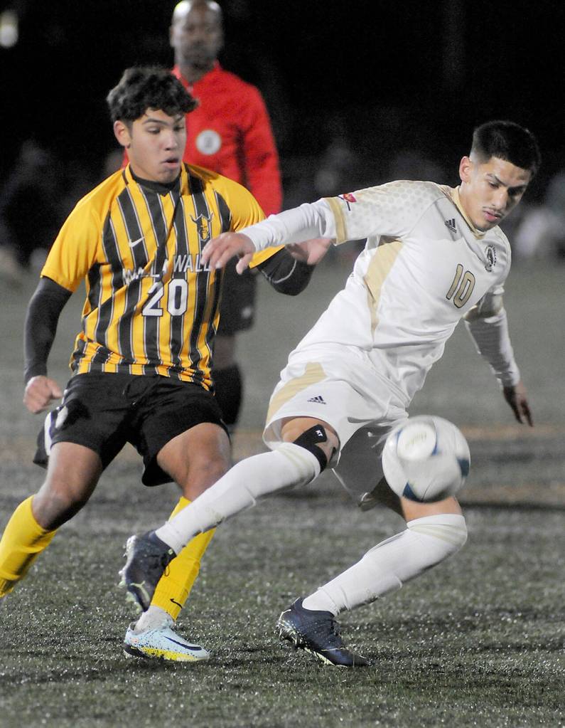 Peninsulas Fernando Tavares keeps the ball away from Walla Wallas Nathan Alvarado during Saturdays NWAC semifinal match at Peninsula College in Port Angeles. (Keith Thorpe/Peninsula Daily News)