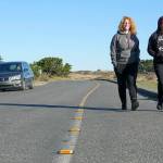 Danielle Osmum, left, and Dina Concepion, both from Las Vegas, walk safely along the newly defined pedestrian, bike and handicapped lane on Harbor Defense Way at Fort Worden State Park earlier this month. The markers were paid for by the Friends of Fort Worden by a donation of one of their members. The new installation is expected to last at least 10 years or longer. (Steve Mullensky/for Peninsula Daily News)