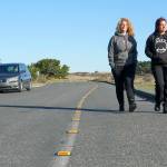 Danielle Osmum, left, and Dina Concepion, both from Las Vegas, walk safely along the newly defined pedestrian, bike and handicapped lane on Harbor Defense Way at Fort Worden State Park earlier this month. The markers were paid for by the Friends of Fort Worden by a donation of one of their members. The new installation is expected to last at least 10 years or longer. (Steve Mullensky/for Peninsula Daily News)