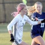 KEITH THORPE/PENINSULA DAILY NEWS
Peninsula's Millie Long, left, races downfield with Spokane's Aubrey Thomas in pursuit during Saturday's NWAC quarterfinal game at Wally Sigmar Field in Port Angeles.