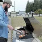 Levi Douglas, Clallam County Veterans program coordinator and U.S. Air Force veteran, cooks burgers and hot dogs during a Veterans Day barbecue for vets and their families at the Clallam County Veterans Center in Port Angeles. The event was one of several across the North Olympic Peninsula honoring those who served their country. (Keith Thorpe/Peninsula Daily News)