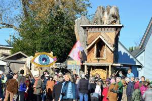 About 75 people gathered in support of Kevin Masons Raccoon Lodge at noon Saturday. The Port Townsend carpenter and artist built the structure on Clay Street with a huge tree stump as its foundation. (Diane Urbani de la Paz/for Peninsula Daily News)