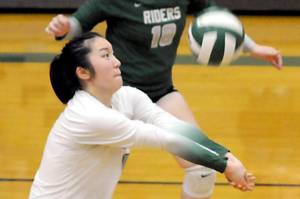 KEITH THORPE/PENINSULA DAILY NEWS
Port Angeles libero Cindy Liang, center, sets the ball in a match in September in Port Angeles. Liang had 94 digs in three matches at the district volleyball tournament.