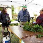 Tuttie Peetz, right, brings her wreath-making equipment and piles of greens, cones and ribbons to the River Center Holiday Nature Mart this weekend. The sale of handcrafted items, holiday wreaths and arrangements, baked goods and candy, is set for Saturday and Sunday to support the Dungeness River Nature Centers education programs. (Submitted photo)