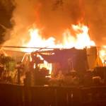 A detached shop burns near a house on Lillian Street in Port Hadlock.
