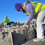 Matthew Nash/Olympic Peninsula News Group 

Megan Caldwell returns to Carrie Blake Community Park to work with her dad Bert to help place meal bags in vehicles during the Family Holiday Food Bag Distribution Day.