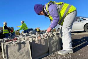 Matthew Nash/Olympic Peninsula News Group 

Megan Caldwell returns to Carrie Blake Community Park to work with her dad Bert to help place meal bags in vehicles during the Family Holiday Food Bag Distribution Day.