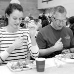 KEITH THORPE/PENINSULA DAILY NEWS
Cecilia Stevenson, of Dallas, left, and her father, Will Stevenson of Port Angeles, say a blessing before enjoying a Thanksgiving meal in the fellowship hall of Queen of Angeles Catholic Church in Port Angeles. The church offered a traditional Thanksgiving dinner for the community, with several hundred diners taking advantage of the in-house meal with numerous other dinners sent out for in-home dining.