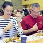 KEITH THORPE/PENINSULA DAILY NEWS
Cecilia Stevenson, of Dallas, left, and her father, Will Stevenson of Port Angeles, say a blessing before enjoying a Thanksgiving meal in the fellowship hall of Queen of Angeles Catholic Church in Port Angeles. The church offered a traditional Thanksgiving dinner for the community, with several hundred diners taking advantage of the in-house meal with numerous other dinners sent out for in-home dining.