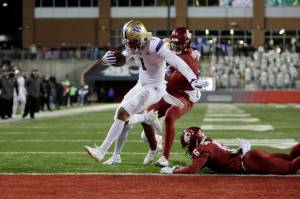 Washington wide receiver Rome Odunze (1) runs for a touchdown during the second half of an NCAA college football game against Washington State, Saturday, Nov. 26, 2022, in Pullman, Wash. Washington won 51-33. (AP Photo/Young Kwak)