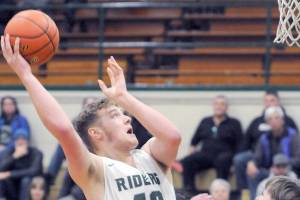 KEITH THORPE/PENINSULA DAILY NEWS
Port Angeles' Isaiah Shamp, left, goes up and over the head of East Jefferson's Stuart Dow on Thursday night in Port Angeles.