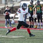Neah Bay's Jodell Wimberley runs with the ball against Liberty Bell in the state 1B football championship game. Neah Bay lost 50-12. (Maria Dorsten/for Peninsula Daily News)
