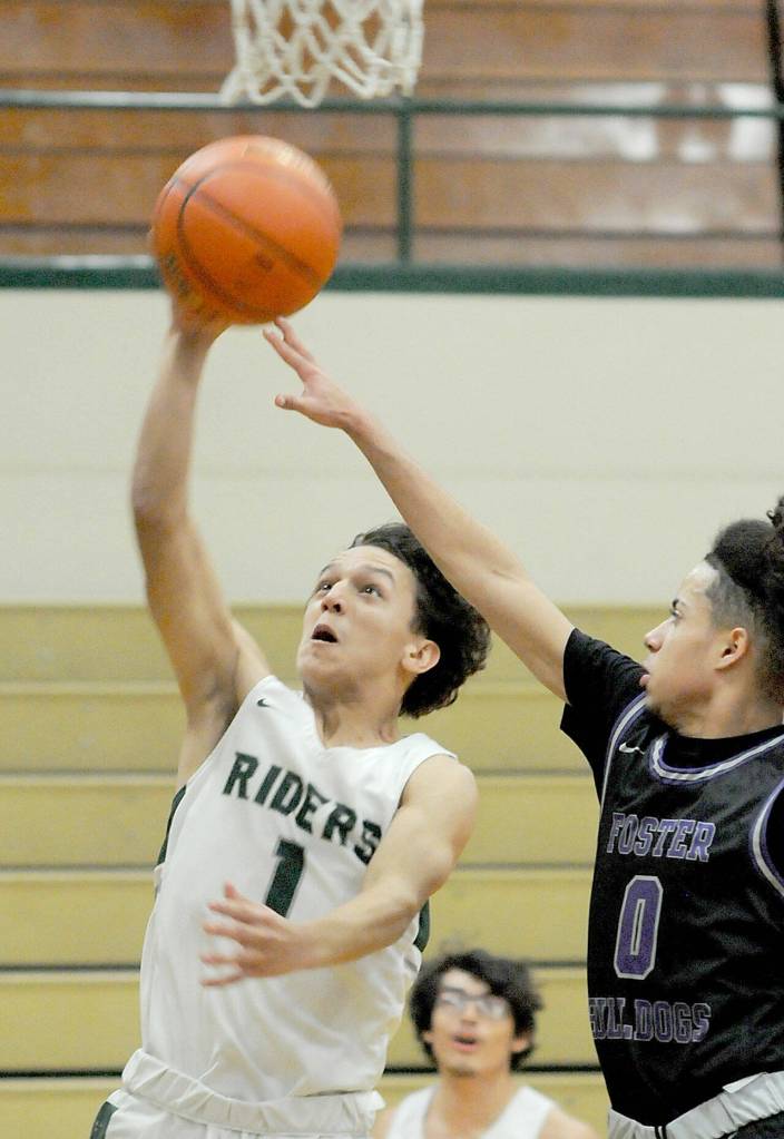 Port Angeles Kason Albaugh, left, looks for the hoop as Fosters Cory Manago tries to defend on Saturday afternoon at Port Angeles High School. (Keith Thorpe/Peninsula Daily News)