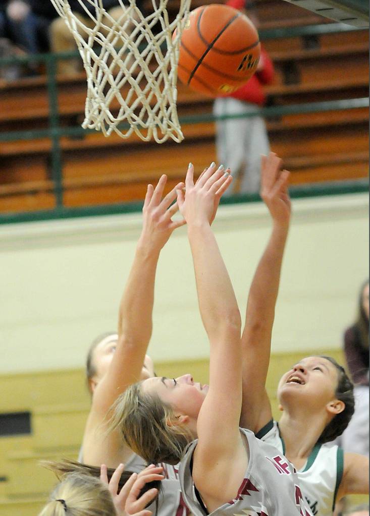 Port Angeles Lindsay Smith, right, puts up the ball as W.F Wests Julia Dalan, left, and Morgan Rogerson, front, scramble for the rebound on Saturday at Port Angeles High School. (Keith Thorpe/Peninsula Daily News)