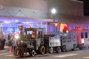 Santa tides down Forks Avenue in the West End Business Professional Association train on Saturday evening during the 21st annual Twinkle Light Parade before lighting the Forks Community Tree at the intersection of Sol Duc Way and Forks Avenue. Before and after the parade, the public viewed the Soroptimist International of the Olympic Rain Forests annual Festival of Trees. Trees were auctioned off Sunday. (Lonnie Archibald/for Peninsula Daily News)