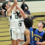 Port Angeles Tyler Hunter, left, grabs a rebound as teammate Ezra Townsend backs him up while Bremertons Trevon Pietz, front, and Oliver Christian, left, look for an opportunity on Tuesday night in Port Angeles. (Keith Thorpe/Peninsula Daily News)