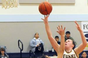 Lonnie Archibald/for Peninsula Daily News
Forks' Keira Johnson scores over North Beach's Malia Cox in Forks on Wednesday evening where Forks defeated North Beach 59-15.