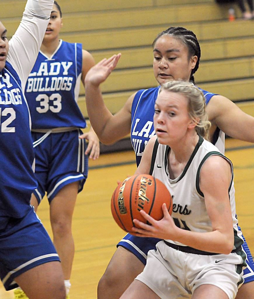 KEITH THORPE/PENINSULA DAILY NEWS Port Angeles Anna Petty, right, is surrounded by the North Mason defense of Tanza Tupolo, left, Adrianne Tupolo and Adrianna Tupolo on Thursday night in Port Angeles.