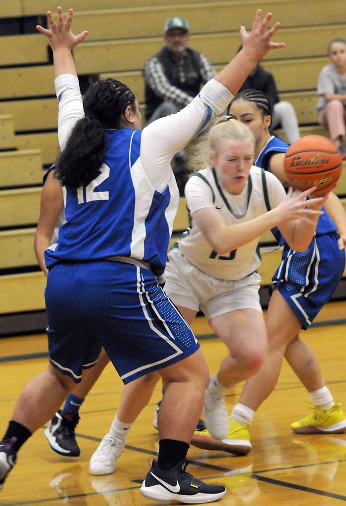 KEITH THORPE/PENINSULA DAILY NEWS Paige Mason of Port Angeles, center, tries to hold on as she slips past North Masons Tanza Tupolo, left, Adrianne Tupolo, right, on Thursday in Port Angeles.