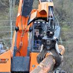 U.S. Rep. Derek Kilmer toured sites where federal grant dollars were being put to work. His visit included a tour of the Port of Port Angeles log yard, where log yard operator Jeremy Weller gave Kilmer a crash course in using a log loader. (Peter Segall/Peninsula Daily News)
