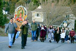 In honor of the Feast of Our Lady of Guadalupe, about 75 people paraded up Harrison Street in Port Townsend toward St. Mary Star of the Sea Catholic Church on Monday afternoon. The police-escorted procession marked the day on which Roman Catholics believe the Virgin Mary appeared to Juan Diego, an indigenous man, in 1531. Mary, known as Our Lady of Guadalupe in Mexico, is the patron saint of that country and the Mother of us all, according to a handout at the parish. St. Mary Star of the Sea, the only Catholic church in Jefferson County, celebrates Sunday masses in Spanish and in English. (Diane Urbani de la Paz/for Peninsula Daily News)