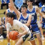 KEITH THORPE/PENINSULA DAILY NEWS
Port Angeles' Nathaneal Surina, left, looks for his teammates as Olympic's Keithen Whitener, center, and Stephen Kugler, rear, defend the lane on Tuesday night in Port Angeles.