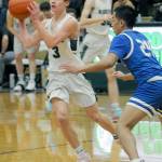 Port Angeles Gus Halberg, left, looks to pass as Olympics Sean Clegg closes in on Tuesday in Port Angeles. (Keith Thorpe/Peninsula Daily News)