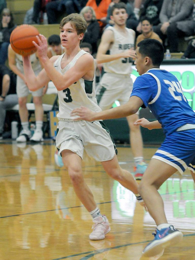 Port Angeles Gus Halberg, left, looks to pass as Olympics Sean Clegg closes in on Tuesday in Port Angeles. (Keith Thorpe/Peninsula Daily News)